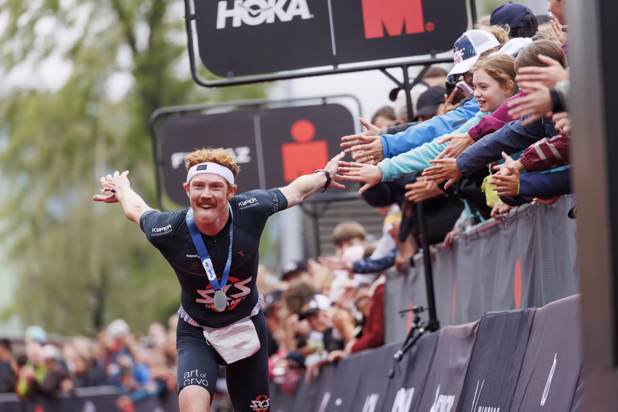 RAPPERSWIL, SWITZERLAND - JUNE 02: Leonard Arnold of Germany reacts after crossing the finish line first during the 2024 IRONMAN 70.3 Switzerland on June 02, 2024 in Rapperswil, Switzerland. (Photo by Jan Hetfleisch/Getty Images for IRONMAN )